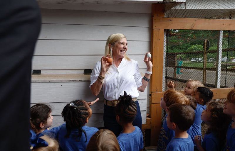 First lady Marty Kemp shows off the chicken coop to pre-K students from Heards Ferry Elementary School on Wednesday.