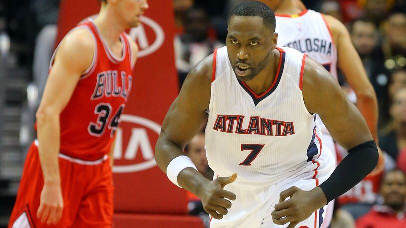 Hawks forward Elton Brand reacts to making a shot against Bulls guard Mike Dunleavy in the final minutes Monday, Dec. 15, 2014, in Atlanta. The Hawks beat the Bulls 93-86.
