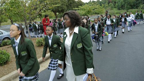 Ivy Prep's founder, Nina Gilbert (right), has reengaged with the school after pursuring other projects for a few years. Ivy Prep closed its Gwinnett County campus, surprising parents and students. In this photo, from 10 years ago, Gilbert and Ivy Prep  students were walking  to Gwinnett County Public Schools Instructional Support Center to protest a lawsuit Gwinnett Schools filed against them.
