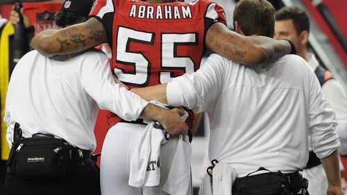 KEY PLAYER INJURED--123012 ATLANTA: Atlanta Falcons John Abraham is helped off the field after being injured in the second half of the season's final game against Tampa Bay in the Georgia Dome in Atlanta on Sunday, December 30, 2012. JOHNNY CRAWFORD / JCRAWFORD@AJC.COM