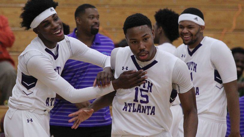 South Atlanta forward Tyler Thornton (15) receives a warm welcome from his team mates at the start of a game in Atlanta on Thursday, Jan. 12, 2017. (Henry Taylor/AJC)