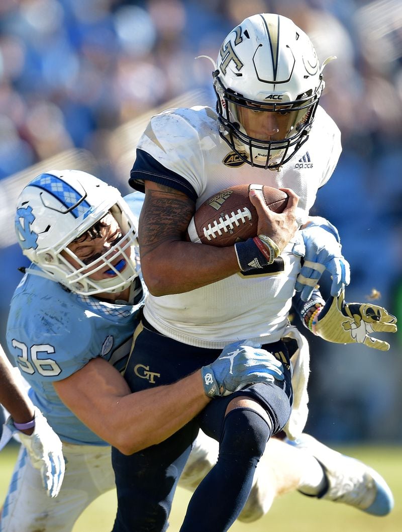 CHAPEL HILL, NC - NOVEMBER 03:  Cole Holcomb #36 of the North Carolina Tar Heels tackles Jordan Mason #24 of the Georgia Tech Yellow Jackets during the second half of their game at Kenan Stadium on November 3, 2018 in Chapel Hill, North Carolina. Georgia Tech won 38-28.  (Photo by Grant Halverson/Getty Images)