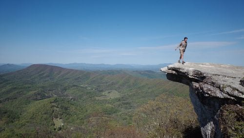 Though the Appalachian Trail Conservancy has asked all through-hikers to leave the trail, a small group has continued their journey, on foot, from Georgia to Maine. Here Henry Wilber, 22, of Atlanta, steps back from the edge of McAfee Knob in Virginia. CONTRIBUTED BY HENRY WILBER
