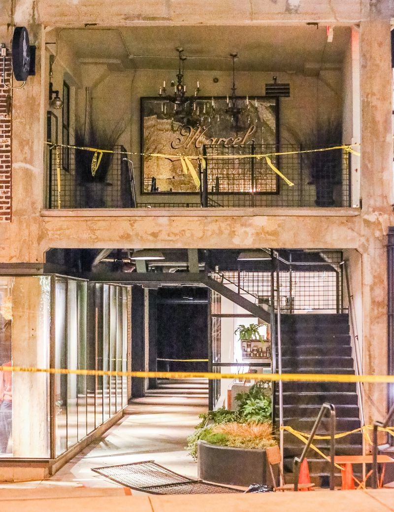 Two men were injured Wednesday night when a railing collapsed in Midtown. JOHN SPINK / JSPINK@AJC.COM