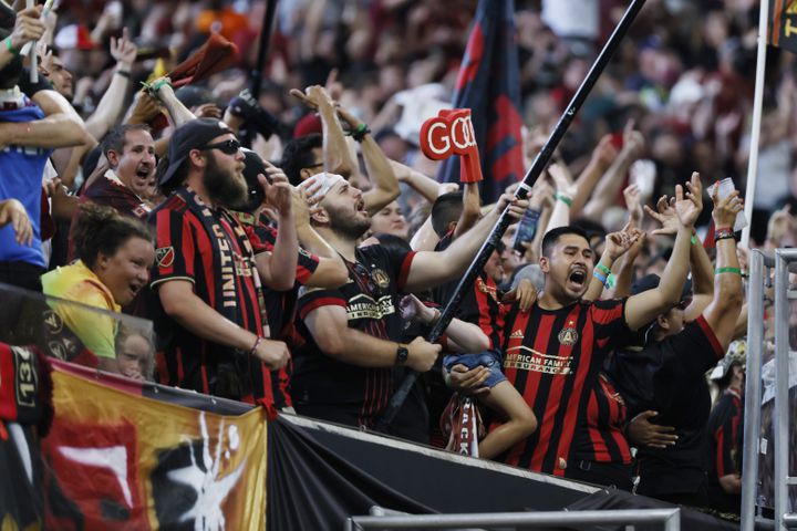 Atlanta United fans celebrate the team's first goal to tie the game 1-1 during the second half Sunday at Mercedes-Benz Stadium. (Miguel Martinez /Miguel.martinezjimenez@ajc.com)