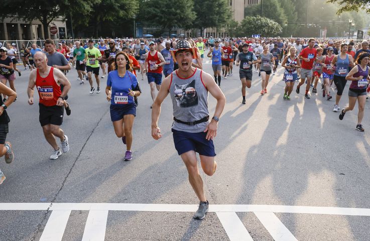 Runners in the 53rd running of the Atlanta Journal-Constitution Peachtree Road Race in Atlanta on Sunday, July 3, 2022. (Miguel Martinez / Miguel.Martinezjimenez@ajc.com)