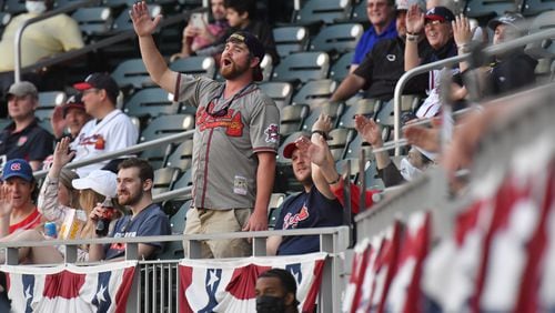 Braves fans perform the "Tomahawk Chop" in the first inning Sunday, April 11, 2021, at Truist Park in Atlanta. (Hyosub Shin / Hyosub.Shin@ajc.com)