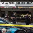 Law enforcement officers are seen on West Peachtree Street in front of Northside Hospital Midtown medical office building, where five people were shot on Wednesday, May 3, 2023. (Arvin Temkar/The Atlanta Journal-Constitution)