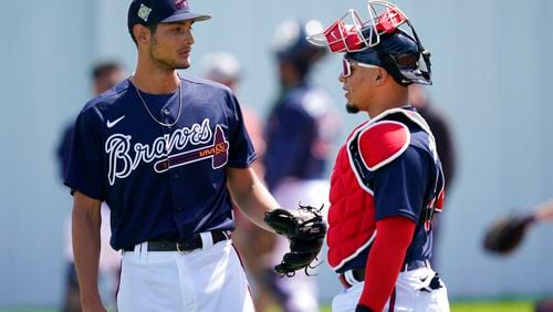 Atlanta Braves pitcher, Freddy Tarnok, left, talks with catcher William Contreras after warm ups during spring training at the CoolToday Park Monday March 14, 2022, in North Port, Fla. (AP Photo/Steve Helber)