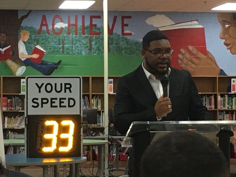 Prophet Lahtrey Majors speaks to a crowd at Seaborn Lee Elementary School in South Fulton on Oct. 21, 2019. They were were to commemorate the first school zone speeding camera installed in the city. The effort honors his daughter, 11-year-old Ren gia Majors, who died in 2018 during a school zone crash. (Ben Brasch/AJC)