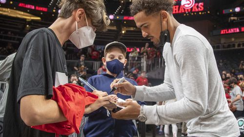 Hawks guard Trae Young (11) signs autographs for fans after Atlanta lost 96-99 to the Cleveland Cavaliers in a preseason game Wednesday, Oct. 6, 2021, at State Farm Arena in Atlanta. (Alyssa Pointer/ Alyssa.Pointer@ajc.com)