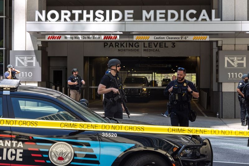 Law enforcement officers are seen on West Peachtree Street in front of Northside Hospital Midtown medical office building, where five people were shot on Wednesday, May 3, 2023. One person died. (Arvin Temkar/The Atlanta Journal-Constitution/TNS)