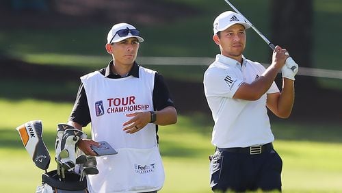 Xander Schauffele and his caddie line up his third shot on the 18th hole where he finished with a par at 11 under during the second round of the Tour Championship at East Lake Golf Club on Saturday, Sept. 5, 2020 in Atlanta.  Curtis Compton / Curtis.Compton@ajc.com