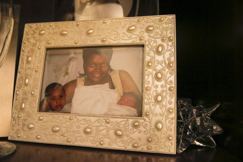 A family photo of Allison McDaniel and her two sons, Corey Jr. (left) and Christian is displayed in their Stone Mountain residence. Her death left her husband, Corey, to raise their sons as a single father. There’s a growing number of single fathers in the U.S. ALYSSA POINTER / ALYSSA.POINTER@AJC.COM