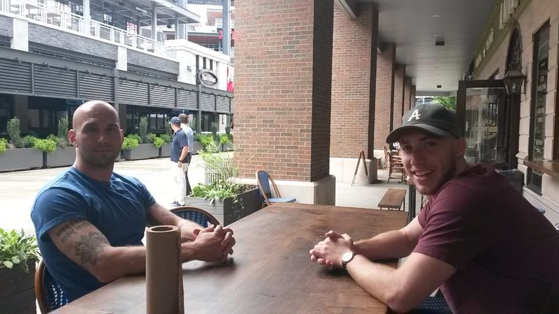 Tayler Moosa (left) and Reid Gan say they often visit the restaurants and entertainment spots at The Battery Atlanta, a mixed-used development beside the Atlanta Braves’ SunTrust Park in Cobb County. Both work within a couple miles of the project. MATT KEMPNER / AJC