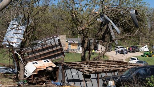 Metal sidings are throw up in trees on Ethan Steenbach's property Tuesday morning, April 16, 2024, in Overbrook, Kan., following a tornado that hit the area. Strong storms have caused damage in parts of the middle U.S. and spawned tornadoes in Kansas and Iowa. (Evert Nelson/The Topeka Capital-Journal via AP)