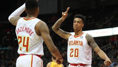 Hawks forward John Collins reacts when Kent Bazemore hits a 3-pointer against the Utah Jazz during a 104-90 victory in a NBA basketball game on Monday, January 22, 2018, in Atlanta.   Curtis Compton/ccompton@ajc.com