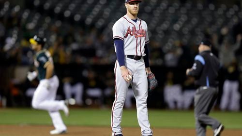 Atlanta Braves pitcher Mike Foltynewicz, center, waits for Oakland Athletics' Matt Olson, left, to run the bases on a home run during the ninth inning of a baseball game Friday, June 30, 2017, in Oakland, Calif. (AP Photo/Ben Margot)