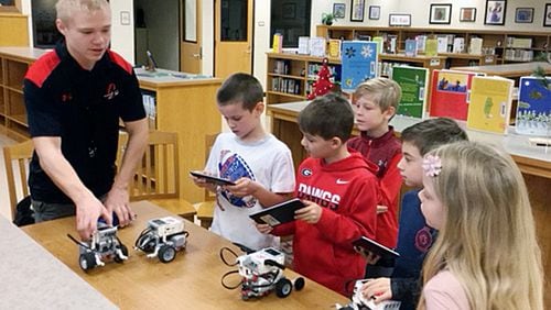 Cherokee High School student Thomas Crosswhite shows the basics of coding robots to Knox Elementary School students (from left) Luke Hill, Isaac Arthur, Landon Buhl, Ben Parker and Emmy Blanton. The Cherokee County School Board plans to name new principals and assistant principals starting in March. CHEROKEE COUNTY SCHOOL DISTRICT