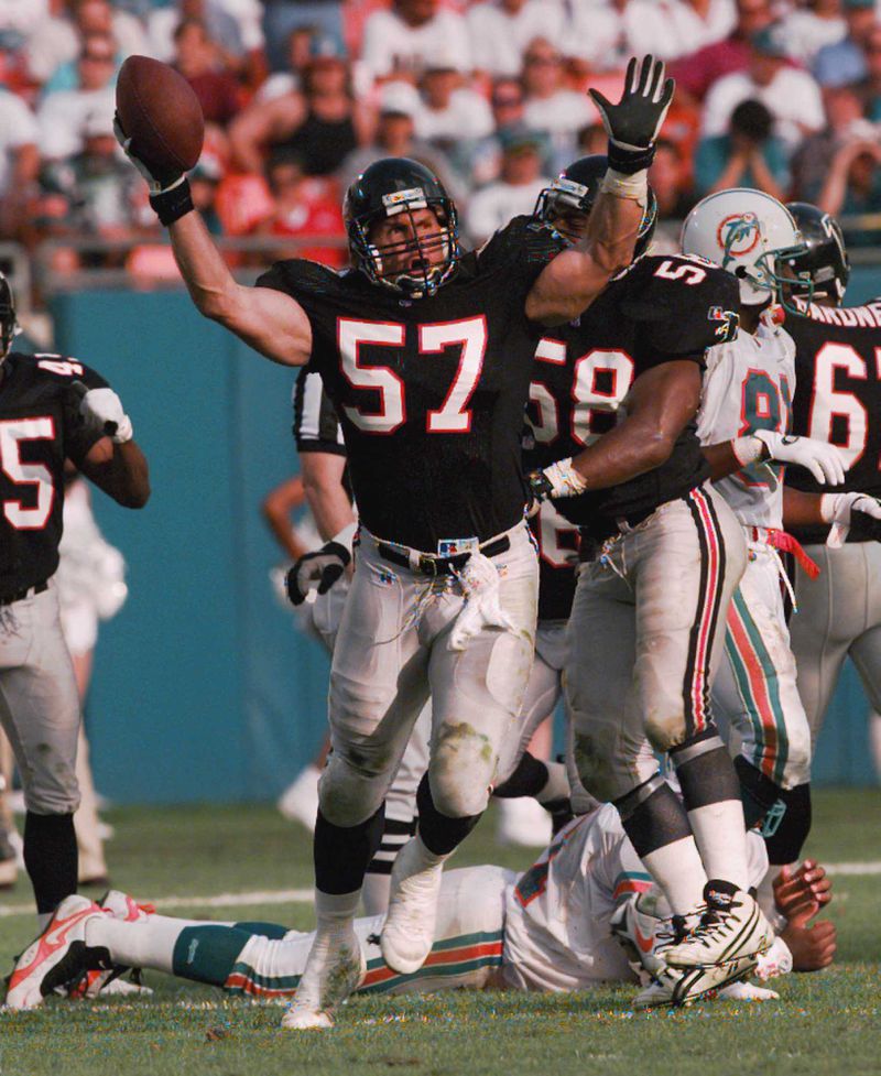 Falcons' Clay Matthews (57) celebrates after intercepting a pass from Miami Dolphins' quarterback Dan Marino on Dec. 3, 1995. (AP Photo/Hans Deryk)