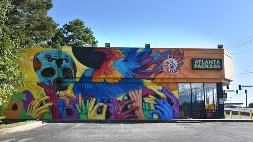 Artist Roberto Hernandez's recently painted mural on Buford Highway reflects the story of  undocumented immigrants such as himself who he said strive for freedom, as represented by the bird, and education, as represented by the nautilus shell.  HYOSUB SHIN / HSHIN@AJC.COM