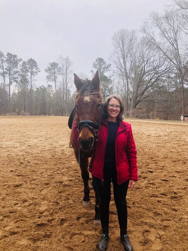 Denise Davidson with Travis, the off-the-track Thoroughbred gelding she leases and rides at Ellenwood Equestrian Center.