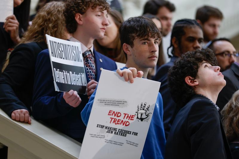 Members of the Jewish community and supporters hold signs during a press conference in February at the Georgia Capitol to promote legislation that would make antisemitism part of Georgia's hate crimes law. The bill cleared the Georgia House during the 2023 legislative session but stalled in the state Senate. (Natrice Miller/ natrice.miller@ajc.com) 