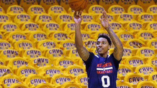 Jeff Teague gets off a shot with Cavaliers' shirts covering the seats while the Hawks conduct shoot around at Quicken Loans Arena before game 3 of the Eastern Conference Finals on Sunday. (Curtis Compton/ccompton@ajc.com)