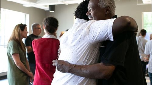 Pastor Tegga Lendado hugs an attendee before Rally for Resettlement, a solidarity event for refugees and agencies, held at Clarkston International Bible Church in Clarkston, Georgia, in September, 2019. (Photo/Rebecca Wright for the Atlanta Journal-Constitution)
