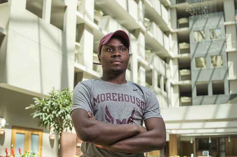Morehouse College Economics senior Collins Kiplimo stands for a portrait in the lobby of his temporary residence at the Embassy Suites Hotel in downtown Atlanta, Thursday, April 16, 2020. Morehouse College is housing some of the students at the hotel as they finish out the semester. Kiplimo is from Kenya. (ALYSSA POINTER / ALYSSA.POINTER@AJC.COM)