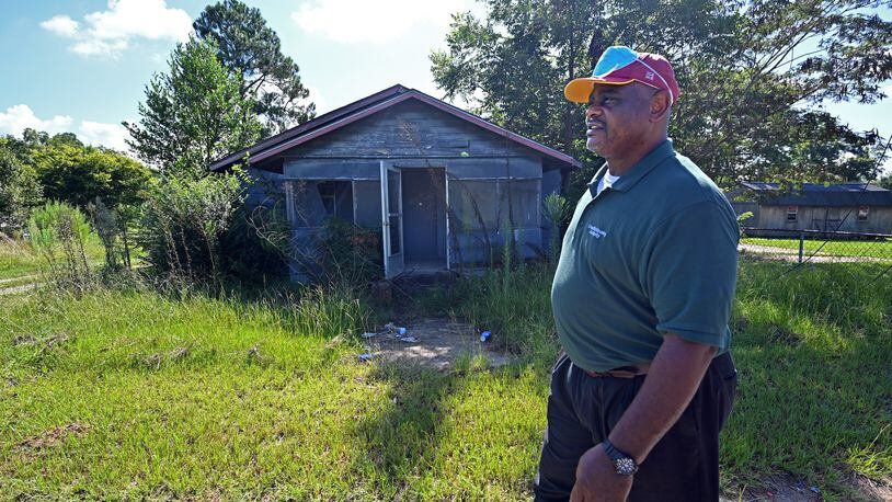 August 18, 2021 Unadilla - Tony Lester, Dooly County Commissioner, walks pass an abandoned house on West Avenue near the Unadilla Housing Authority building in Unadilla on Wednesday, August 18, 2021. New U.S. Census data shows Dooly, where long expanses of farm land give way to small, sleepy towns, lost nearly a fifth of its population from 2010 to 2020, making it Georgia's top shrinking county. Meanwhile, only 15 counties grew more by percentage than Houston County, home to agricultural hub Perry and Robins Air Force Base. (Hyosub Shin / Hyosub.Shin@ajc.com)