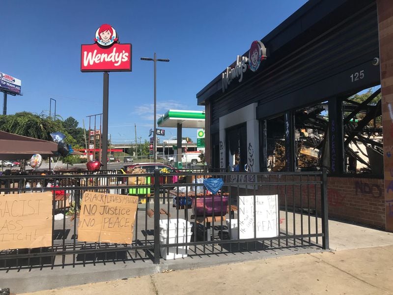 People came to pay their respects to Rayshard Brooks outside the Wendy's early Friday, June 19, 2020. 