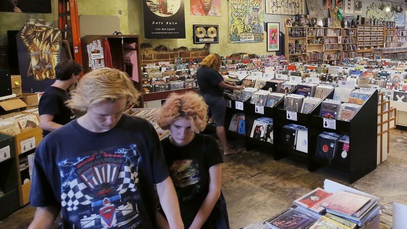 Customers look through the bins of vinyls at Criminal Records in Little Five Points. It is a locally owned and independently operated new and used record store that has hard-to-find LPs and CDs, plus comic books and music magazines. BOB ANDRES / BANDRES@AJC.COM
