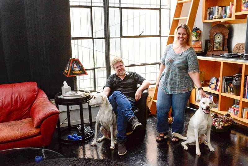 Steven and Carrie Burns, with their dogs, Watson (left) and Sherlock, have lived in this loft in the Mueller building for a decade. He works for Look Listen as a software developer, and she owns and operates Atlanta Movie Tours. A love of movies contributed to many design choices throughout the home.