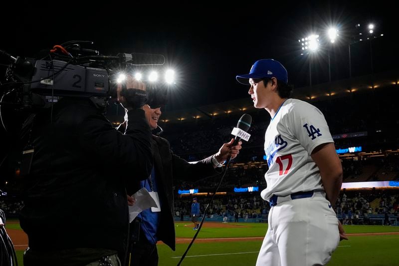 Los Angeles Dodgers designated hitter Shohei Ohtani (17) speaks to a reporter after an 11-2 win over the Atlanta Braves in a baseball game in Los Angeles, Saturday, May 4, 2024. (AP Photo/Ashley Landis)