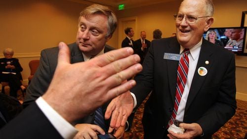 In a 2010 election night event, Ralph Hudgens, right, Republican candidate for Commissioner of Insurance, shakes hands with supporters while watching returns come in. Curtis Compton ccompton@ajc.com