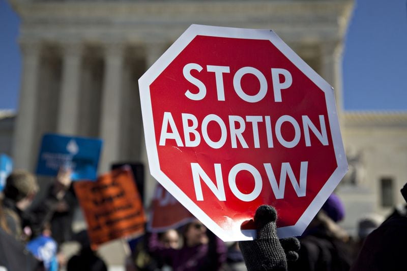 A demonstrator holds up a sign in support of pro-life rights outside the U.S. Supreme Court in Washington on March 2, 2016.