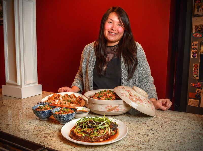 Jennifer McCormick, whose parents came to the U.S. from Taiwan, shares some recipes for celebrating the Lunar New Year: Fish Fillet with Soy-Ginger Sauce (front), Pork and Cabbage Dumplings (Jiaozi) (left rear) and Sticky Rice with Chicken, Mushrooms and Chinese Sausage (large bowl on right and two smaller bowls left). STYLING BY JENNIFER MCCORMICK / CONTRIBUTED BY CHRIS HUNT PHOTOGRAPHY