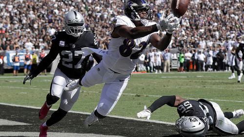 Baltimore Ravens tight end Benjamin Watson (82) cannot catch a pass in the end zone in front of Oakland Raiders free safety Reggie Nelson (27) during the first half of an NFL football game in Oakland, Calif., Sunday, Oct. 8, 2017. (AP Photo/Marcio Jose Sanchez)