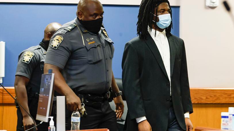 Jayden Myrick enters the courtroom to testify during his murder trial Wednesday morning. He is accused of robbing and fatally shooting Christian Broder outside an event venue in 2018.  (Natrice Miller/natrice.miller@ajc.com)