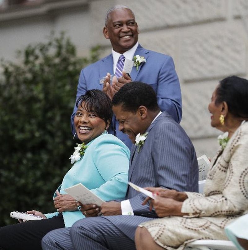 The Rev. Bernice King, left, and Isaac Farris, center, the daughter and nephew of Rev. Martin Luther King Jr., attend the unveiling ceremony with Georgia Sen. Emanuel Jones, standing, and Christine King Farris. (AP photo/David Goldman)