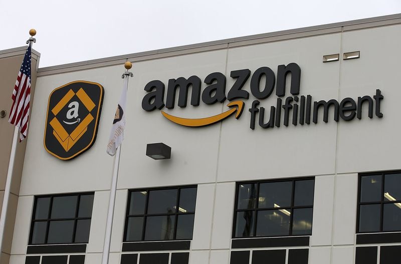 A sign is posted on the exterior of an Amazon fulfillment center in Tracy, California. Amazon said it will open a new “fulfillment center” in Macon as part of its mission to speed up delivery of products to consumers. (Photo by Justin Sullivan/Getty Images)