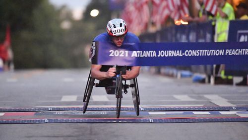 Daniel Romanchuk defended his title and won his fourth Atlanta Journal-Constitution Shepard Center men’s wheelchair division title Sunday morning as the AJC Peachtree Road Race returned in-person for the second day Sunday for the holiday tradition.  Hyosub Shin / Hyosub.shin@ajc.com