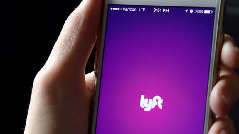 FILE PHOTO: The Lyft app is seen on a passenger's phone. (Photo by Mike Coppola/Getty Images for Lyft)
