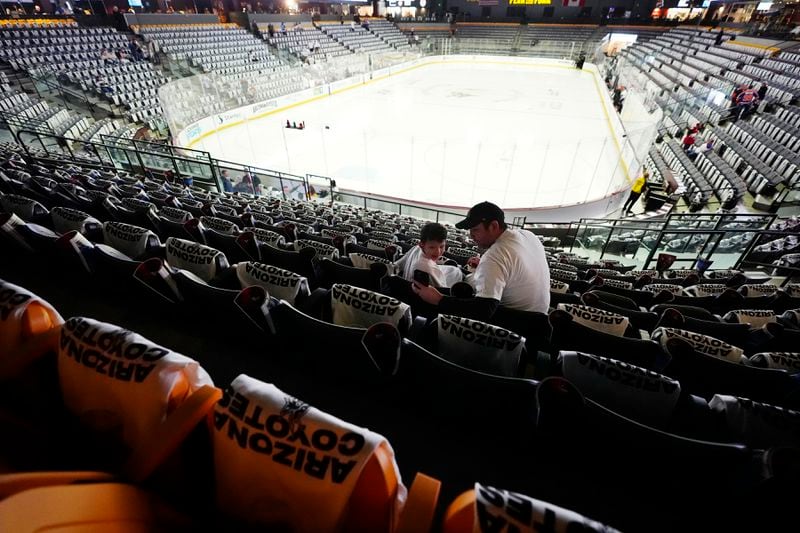 Arizona Coyotes fans start to find their seats at Mullett Arena prior to the team's NHL hockey game against the Edmonton Oilers on Wednesday, April 17, 2024, in Tempe, Ariz. The team is expected to be sold and moved to Sale Lake City. (AP Photo/Ross D. Franklin)