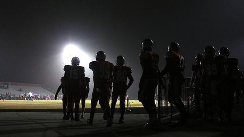 December 5, 2014 - Lawrenceville, Ga: Archer players walk onto the field before their game against Etowah in the Class AAAAAA semifinal Friday night at Archer High School in Lawrenceville, Ga., December 5, 2014. PHOTO / JASON GETZ