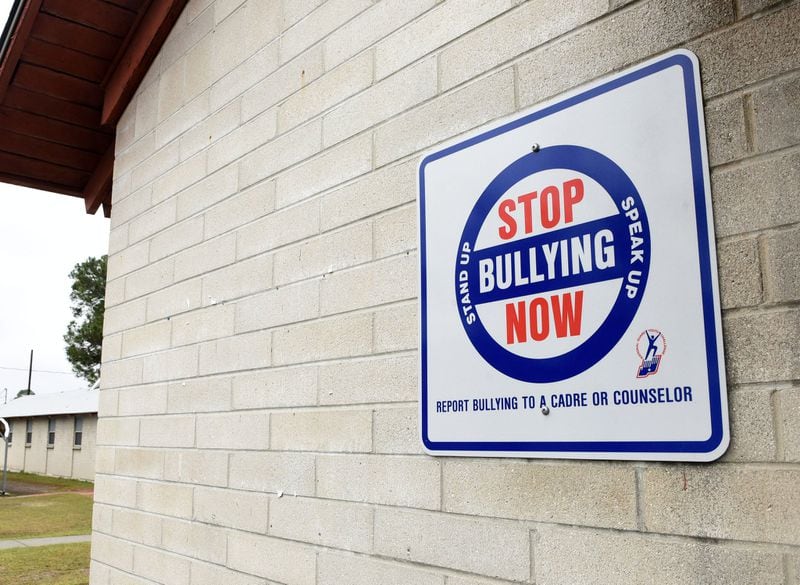 A sign posted at the Fort Stewart Youth Challenge Academy implores cadets to report bullying to a counselor or a drill instructor. Public records reviewed by the AJC showed female employees have suffered ill treatment at the academy, too, including sexism and sexual harassment. RYON HORNE / RHORNE@AJC.COM