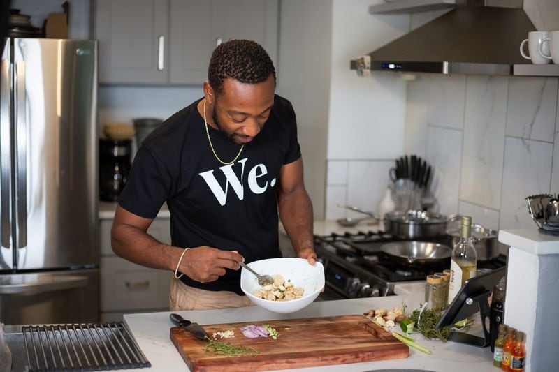 Life Bistro chef Issa Prescott, shown in his home kitchen in Midtown, went vegan but missed scallops, so he created a version using king trumpet mushrooms. (Ryan Fleisher for The Atlanta Journal-Constitution) 