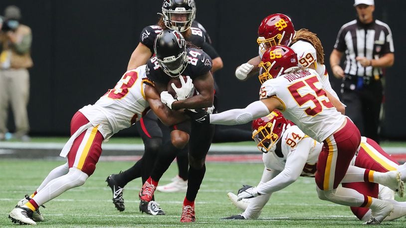 Atlanta Falcons running back Cordarrelle Patterson runs through Washington Football Team defenders for a first down during the first quarter on Sunday, Oct. 3, 2021 at Mercedes Benz Stadium in Atlanta. (Curtis Compton/Atlanta Journal-Constitution/TNS)