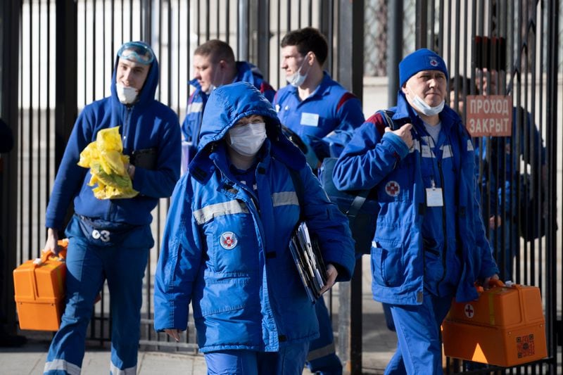 In this photo taken on Friday, Feb. 21, 2020, Medical workers walk after checking passengers where a passenger was identified with suspected coronavirus after arriving from Kyiv at Kievsky (Kyiv's) rail station in Moscow, Russia. Russia suspended all trains to China and North Korea, shut down its land border with China and Mongolia and extended a school vacation for Chinese students until March 1. Russian authorities are going to great lengths to prevent the new coronavirus from spreading in the capital and elsewhere. 
